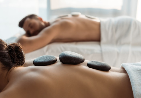 Premium Couples Massage Package Incl. Massage, Hot Stone Therapy, Ginger Tea & Chocolate Treat - Options for 60-Minutes or 90-Minutes